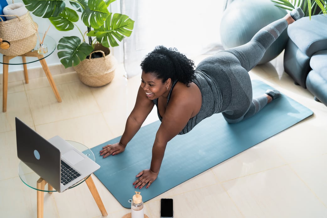 Curvy Woman Doing Pilates Virtual Fitness Class at Home